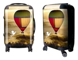 A wheeled suitcase features a colourful hot air balloon design and includes a logo. The suitcase is predominantly yellow and red.
