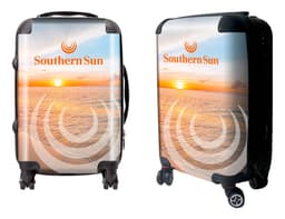 A wheeled suitcase featuring a sunset beach design with a logo. The suitcase has a glossy finish and black wheels.