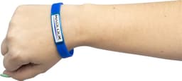 A blue silicon wristband on a wrist, featuring a logo on an attached rectangular plaque.