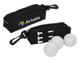 A black pouch with a logo, containing three golf balls and three white tees.