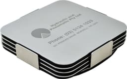 A set of silver coasters stacked together, featuring a sleek design with a logo and contact information.