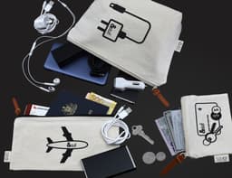 A beige travel set includes bags with various electronic accessories, a phone, cash, coins, and travel documents.