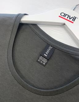 A black T-shirt with a round neckline displayed on a hanger, featuring a logo.