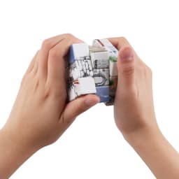 A twist cube puzzle featuring vibrant and intricately printed designs, held in two hands.