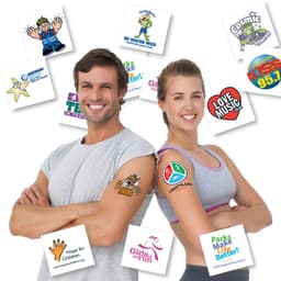 A man and woman smiling, showcasing a variety of colourful temporary tattoos on their arms, with logos in the background.