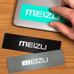 Three rectangular gloss paper stickers in turquoise, black, and grey, with a logo on each, placed on a wooden surface.