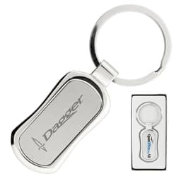 A silver keychain with a sleek design and a circular keyring, presented in a black box. It features a logo.