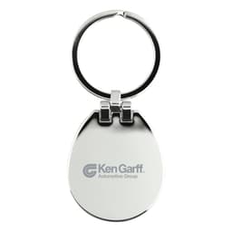 A silver keychain with a rounded shape and a ring, featuring a logo on one side.