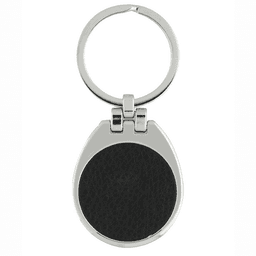 A silver keychain with a teardrop shape and a black textured surface.