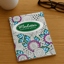 An A4 colouring book with intricate floral designs in purple, blue, and green on a white cover, featuring a logo.