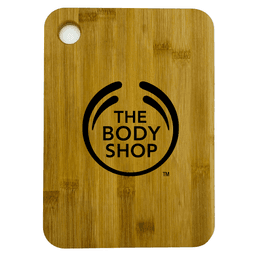A large bamboo cutting board with rounded corners, featuring a logo on the surface.