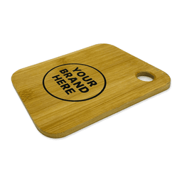 A small bamboo cutting board featuring a circular area for branding and a handle cutout.