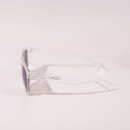 A pair of clear-frame sunglasses with purple lenses, featuring a logo on the side.
