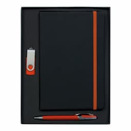 A black notebook with an orange strap, accompanied by a silver and orange pen and a USB drive, in a black presentation box.