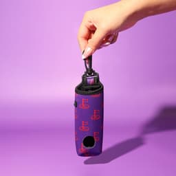 A neoprene golf ball sleeve in purple with a pattern, featuring a strap for easy carrying.