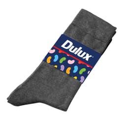 A pair of grey seamless socks with a branded label featuring a colourful design on the band.