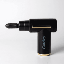 A black massage gun with a gold accent and a detachable applicator head. It features branding on the side.