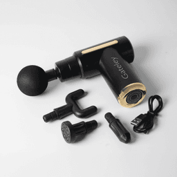 A black and gold massage gun with multiple attachments and a charging cable. It features a logo on the handle.