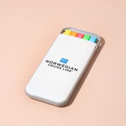 A highlighter set in a white case featuring yellow, orange, pink, and green highlighters, with a logo on the case.