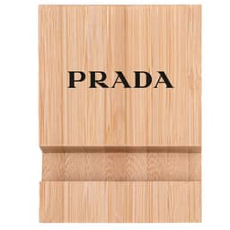 A bamboo phone holder in a natural wood finish featuring a logo on the front.
