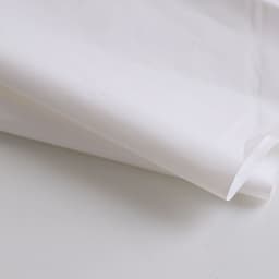 A biodegradable mailer bag in white, featuring a smooth texture and rounded edges. It includes branding details.