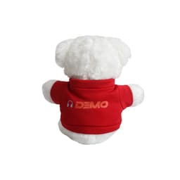 A white bear plush toy wearing a red shirt with a logo on the back, featuring a casual stance.