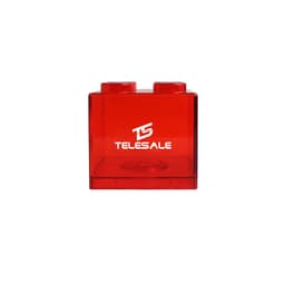 A red square block coin bank with two rounded tops and a logo on the front.