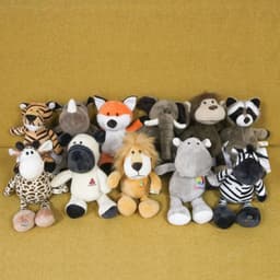A collection of plush toys including a fox, elephant, lion, and various animals in assorted colours.