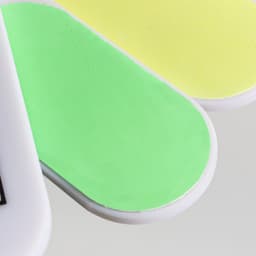 A foldable nail file block featuring green and yellow filing surfaces with a handle. It has a logo on the side.