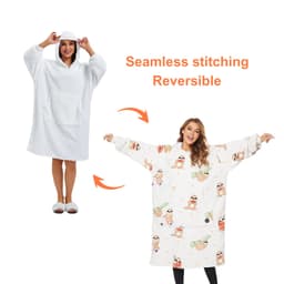 A reversible, wearable blanket in white and patterned designs, featuring a hood and pocket.