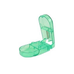 A green pill box with a cutter, featuring a transparent design and a hinged lid. It has a compartment for storing pills.