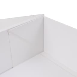 A medium foldable magnetic box in white, highlighting its corners and interior structure. It features a logo.