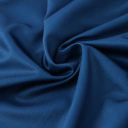A swirl of deep blue polyester fabric, showcasing a smooth texture suitable for sports shorts.