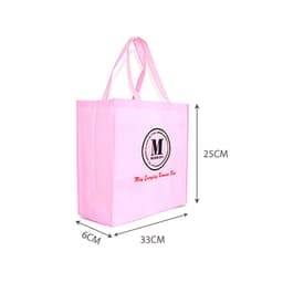 A pink laminated non-woven trade show bag with handles, featuring a circular logo on one side. Dimensions are 33cm x 25cm x 6cm.