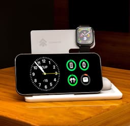 A black 3-in-1 wireless charger featuring a clock display, charging icons, and spaces for a phone and smartwatch.