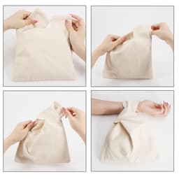 A cream cotton wrist bag is being manipulated, showcasing its flexible design and secure handle.