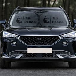 Twin circular black car sun shades displayed on the front windshield of a black SUV, featuring a logo.