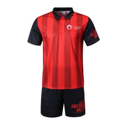 A red and black sports uniform featuring a polo shirt and shorts, with a logo on the shirt and branding on the shorts.