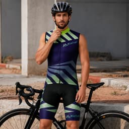 Men's sublimated cycling shorts in shades of purple and green, featuring a logo, modelled by a man with a bike.