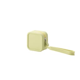 A square silicone coin pouch in a light yellow shade with a zip closure and wrist strap. It has a logo on the surface.