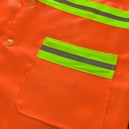 An orange button-down safety vest featuring reflective green stripes and a pocket.