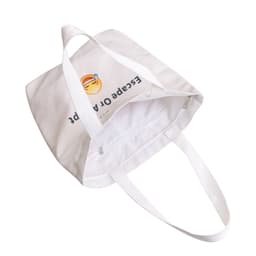 A white velvet tote bag featuring a colourful design on both sides. It has sturdy white handles and an interior zip pocket.