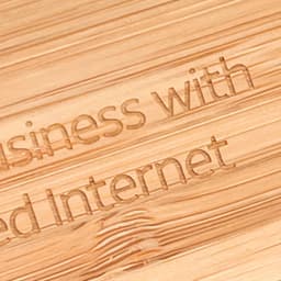 A close-up view of a bamboo surface engraved with text. The bamboo has a natural light brown colour.