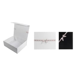 A white gift box with an adhesive ribbon bow in blush pink, displayed open and in close-up.
