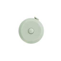 A round, light green tape measure with a white button, featuring a logo on the surface.