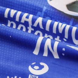 A folded blue sports towel featuring a pattern and an emphasised logo. Ideal for gym and outdoor use.