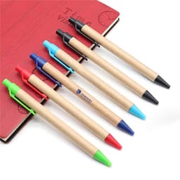 Seven Kraft Paper Pens in various colours—red, blue, green, black—with a notebook in the background.
