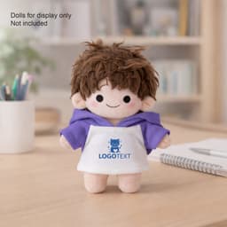 A plush doll with brown hair wearing a purple raglan hoodie and a white front, featuring a logo.