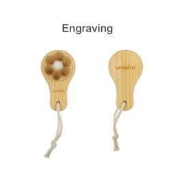 A flower-shaped facial cleansing brush with a wooden handle and a natural bristle head, featuring a hanging loop.