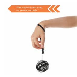 A black and grey wrist ball with a wrist strap, held by a hand, designed for leisure and outdoor activities.